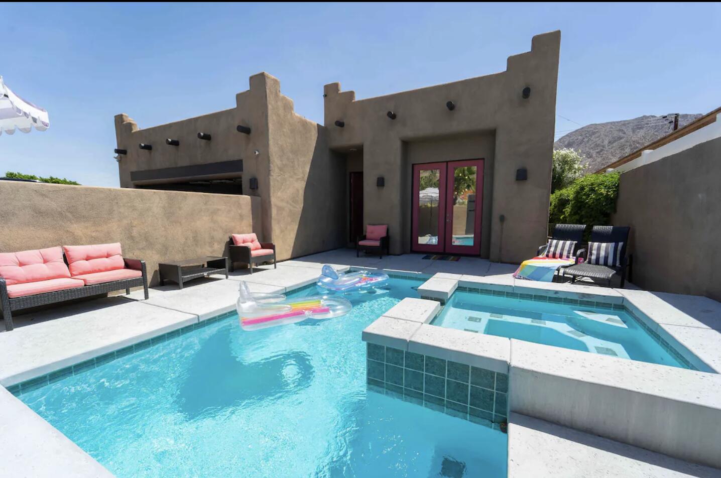 a swimming pool view with a outdoor seating space