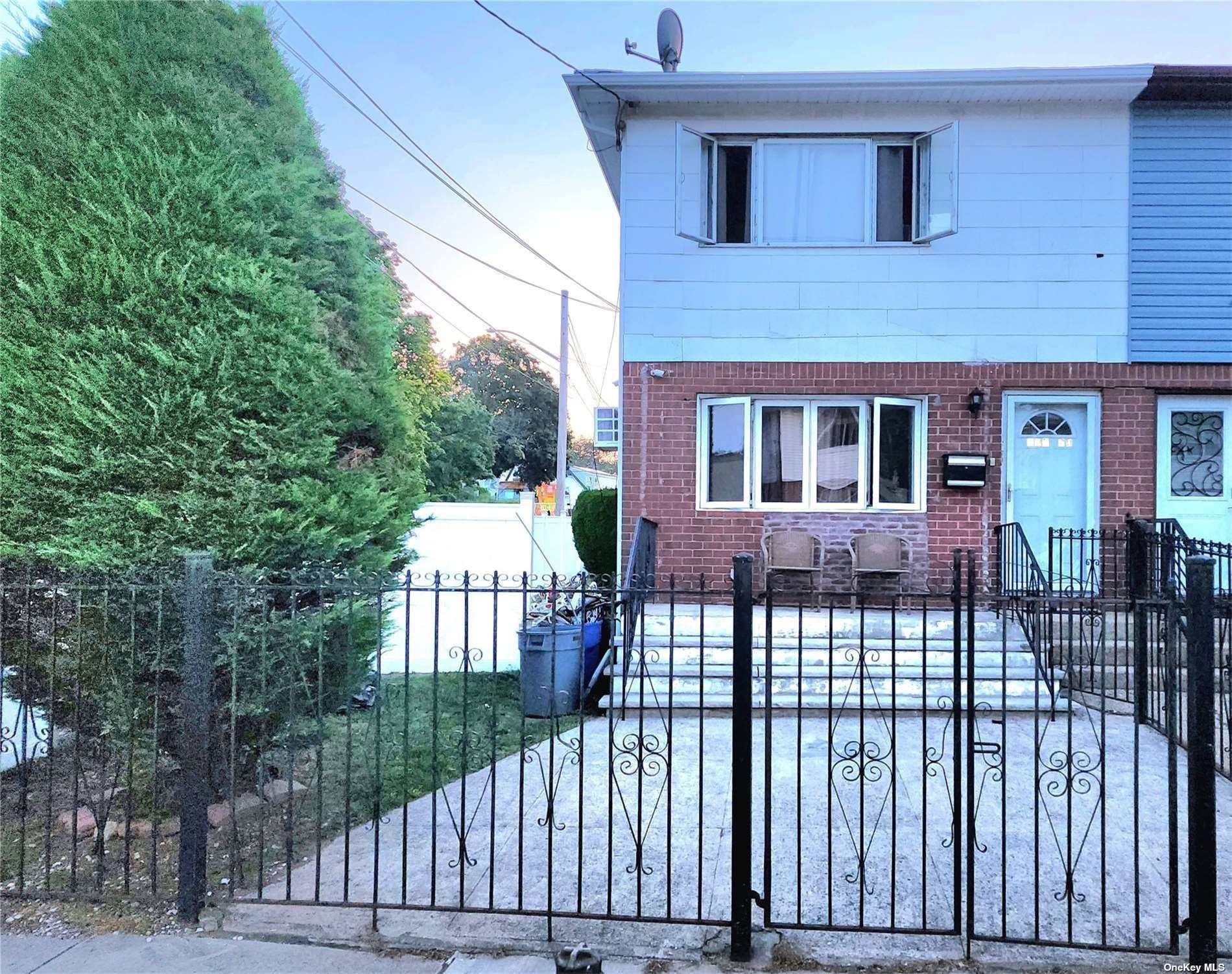 a front view of a house with a fence