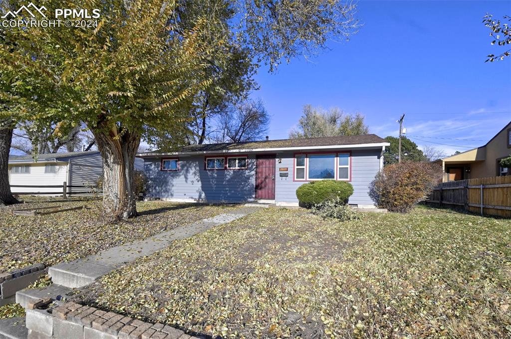 a view of a house with a tree in the yard