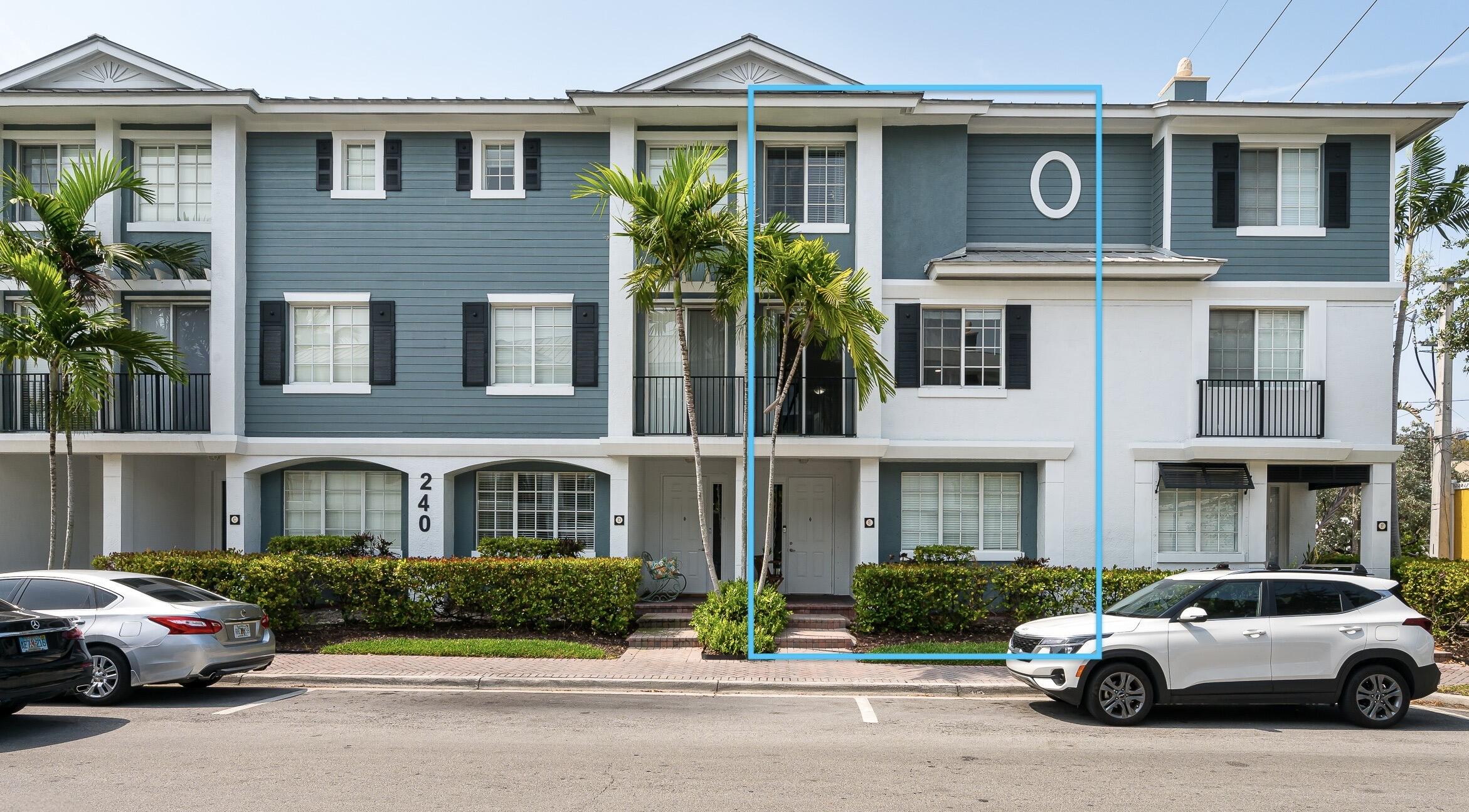 a front view of a residential apartment building with a yard