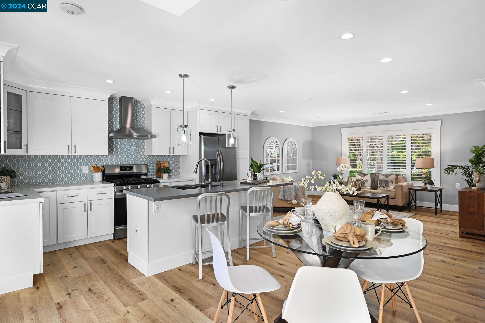 a large kitchen with a table and chairs