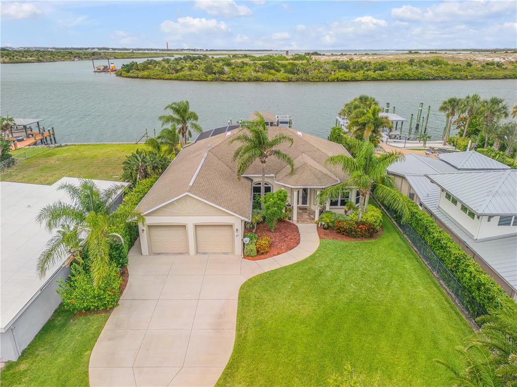 an aerial view of a house with outdoor space and a lake view