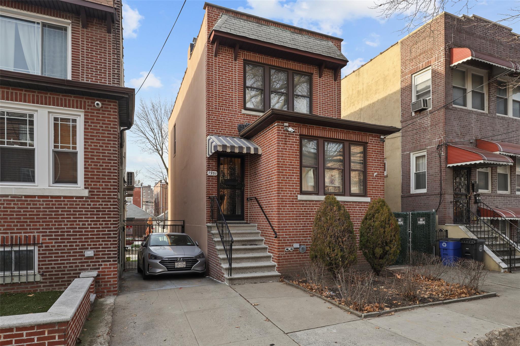 a car parked in front of a brick house