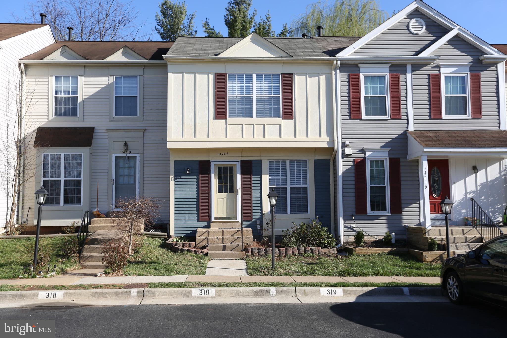 front view of a brick house with a yard