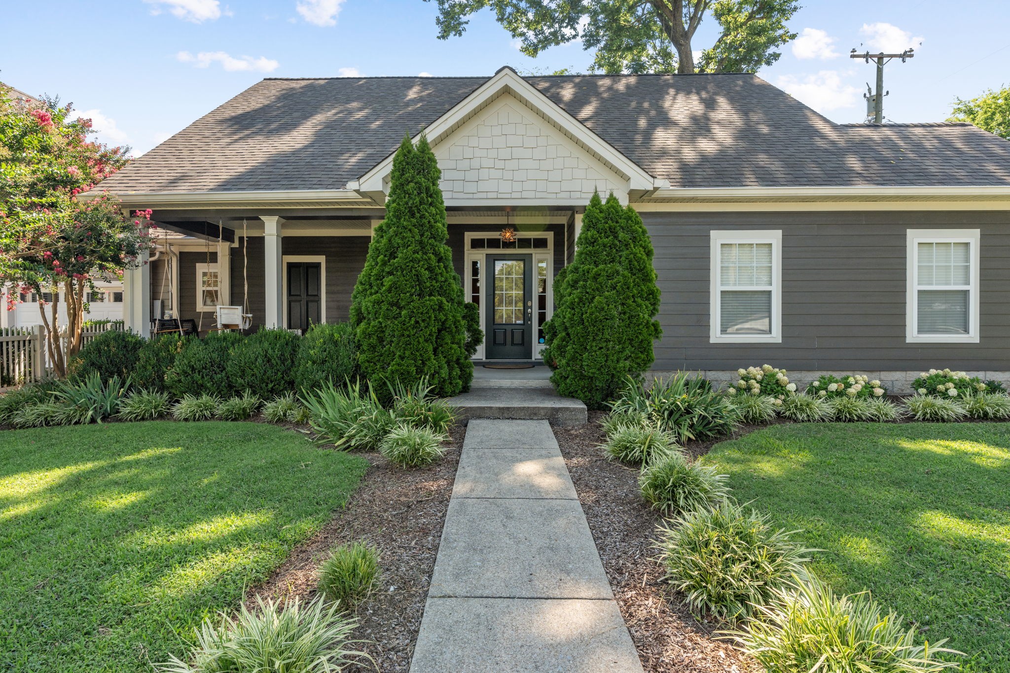 a front view of a house with garden