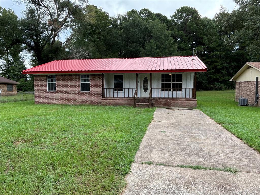 a front view of house with yard barbeque and outdoor seating