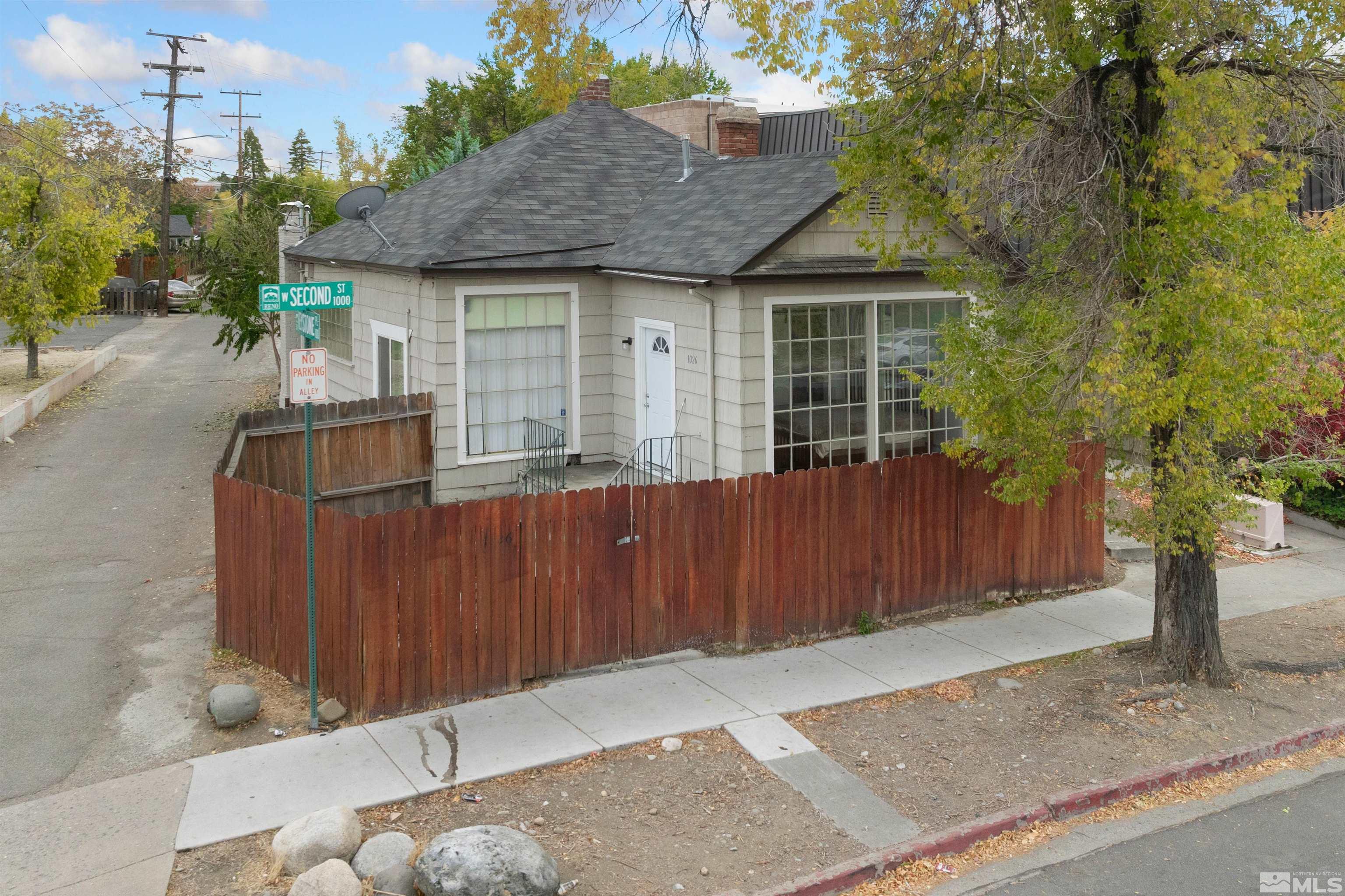 a front view of house with a garden