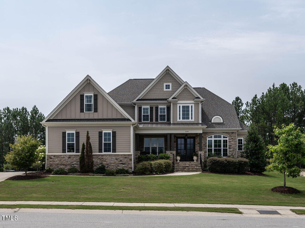 a front view of a house with a garden