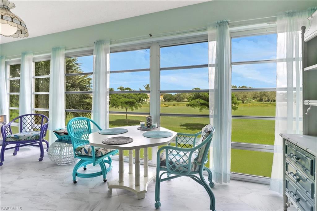 a dining room with furniture and a window