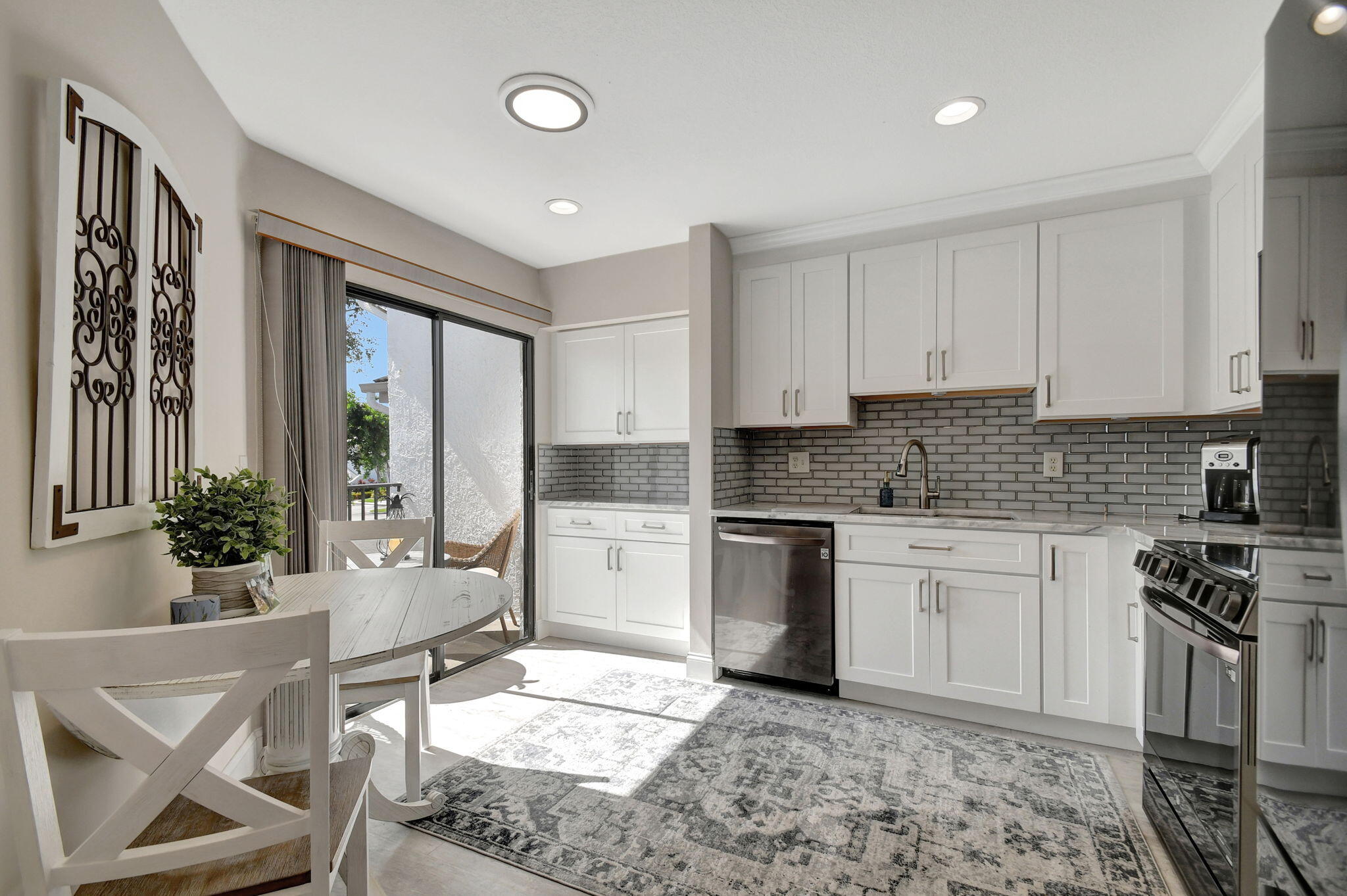 a kitchen with a stove a sink and cabinets