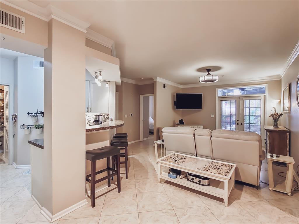 a living room with furniture a flat screen tv and a table