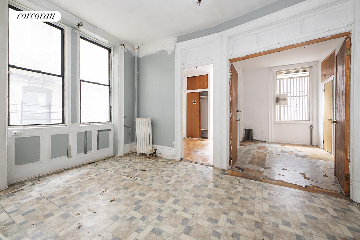 an empty room with windows and closet