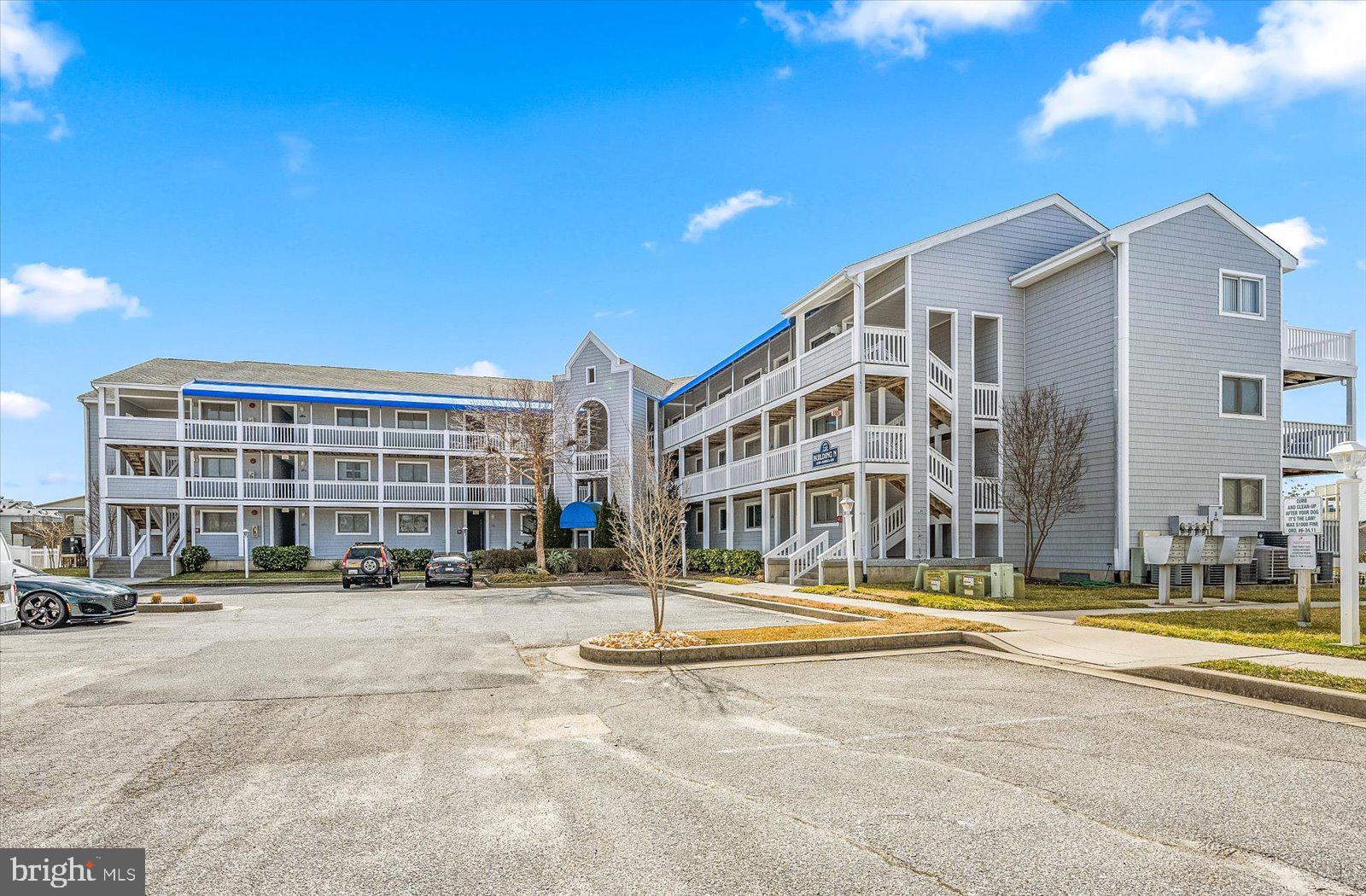 a front view of building with cars parked