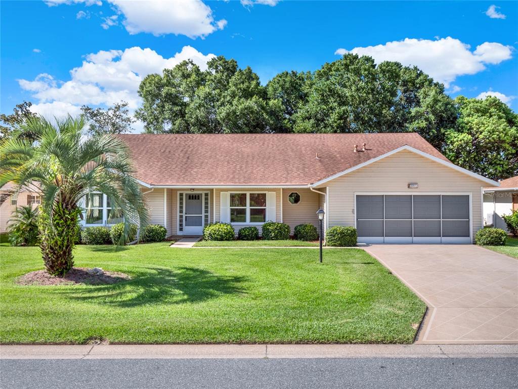 a house that is sitting in middle od the grass