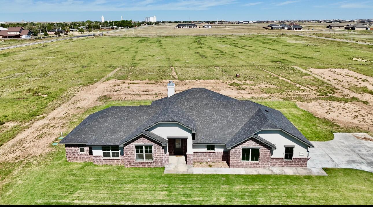 a aerial view of a house with a yard