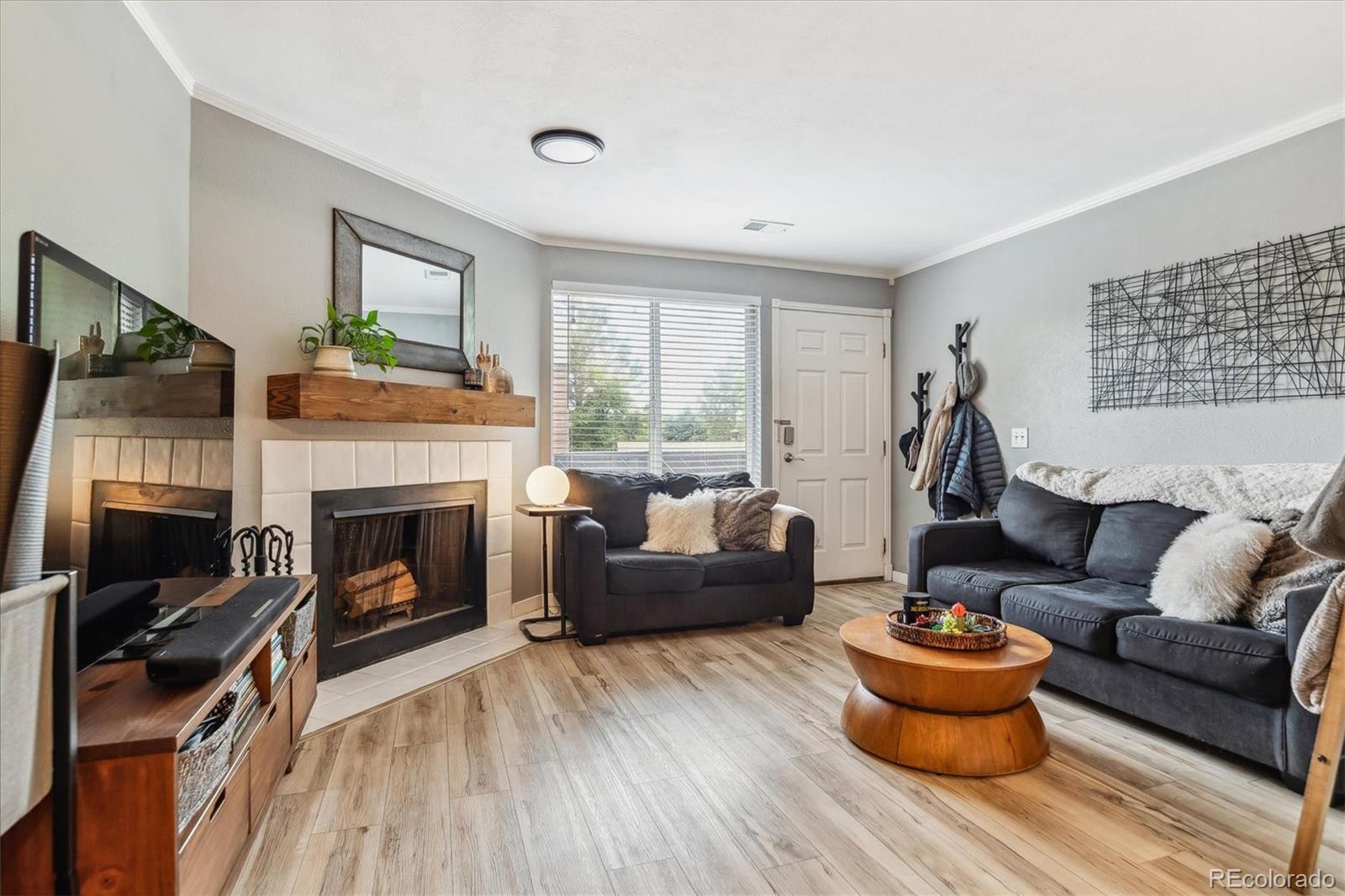 a living room with furniture and a fireplace