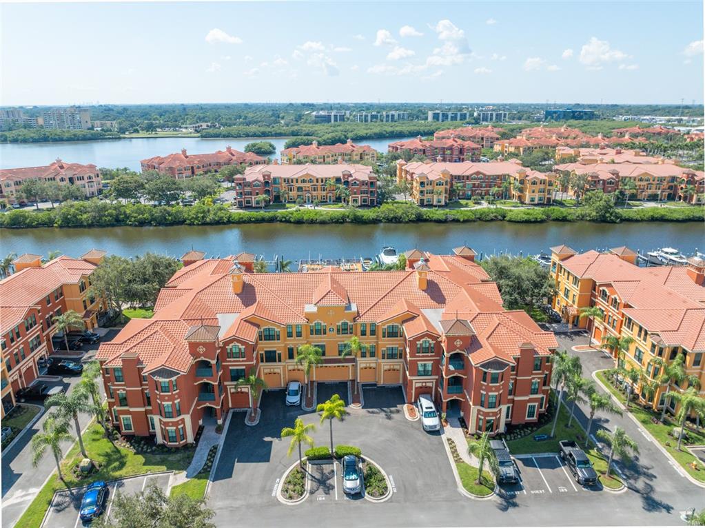 an aerial view of lake and residential houses with outdoor space