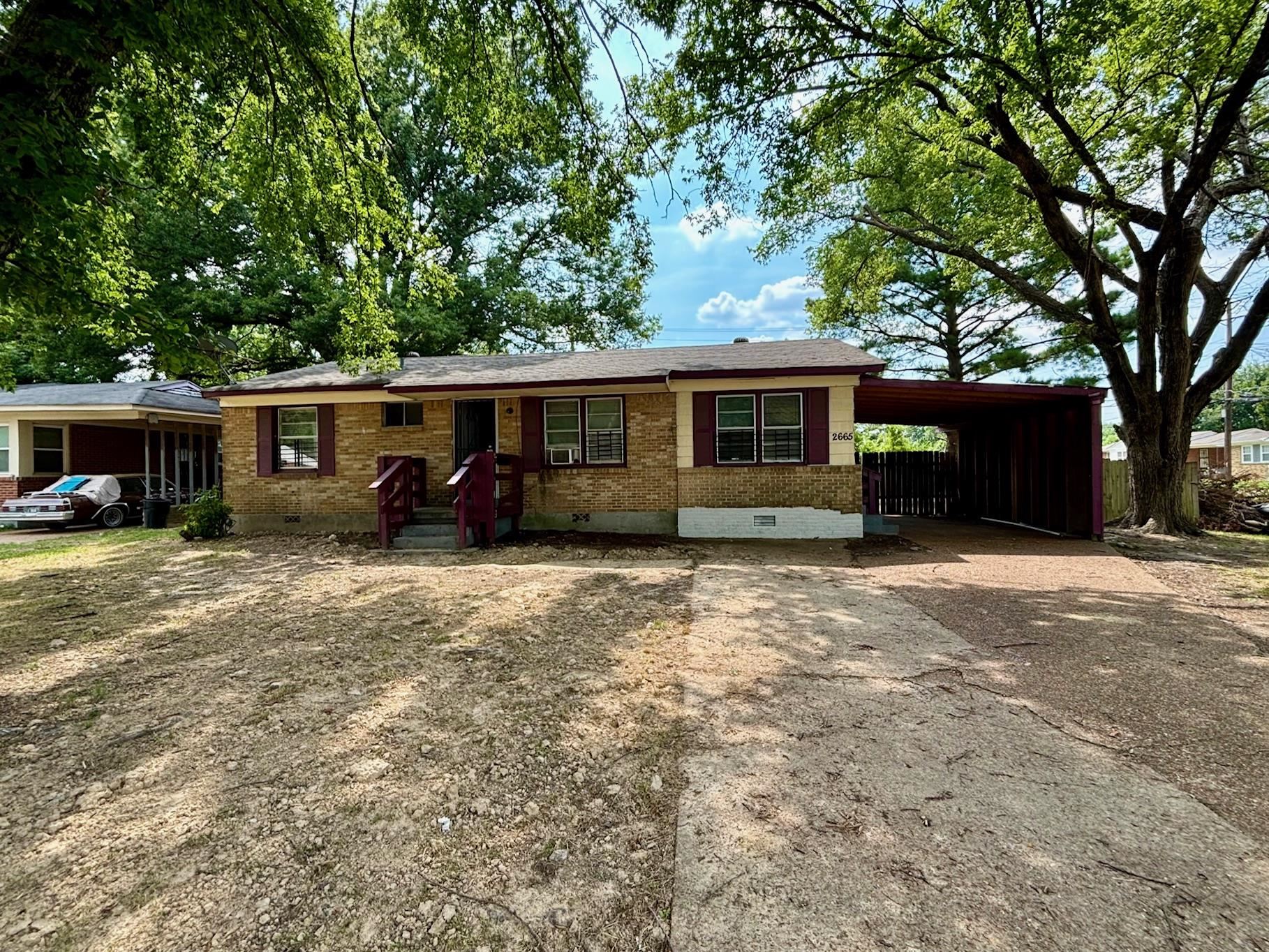 Ranch-style home featuring a carport