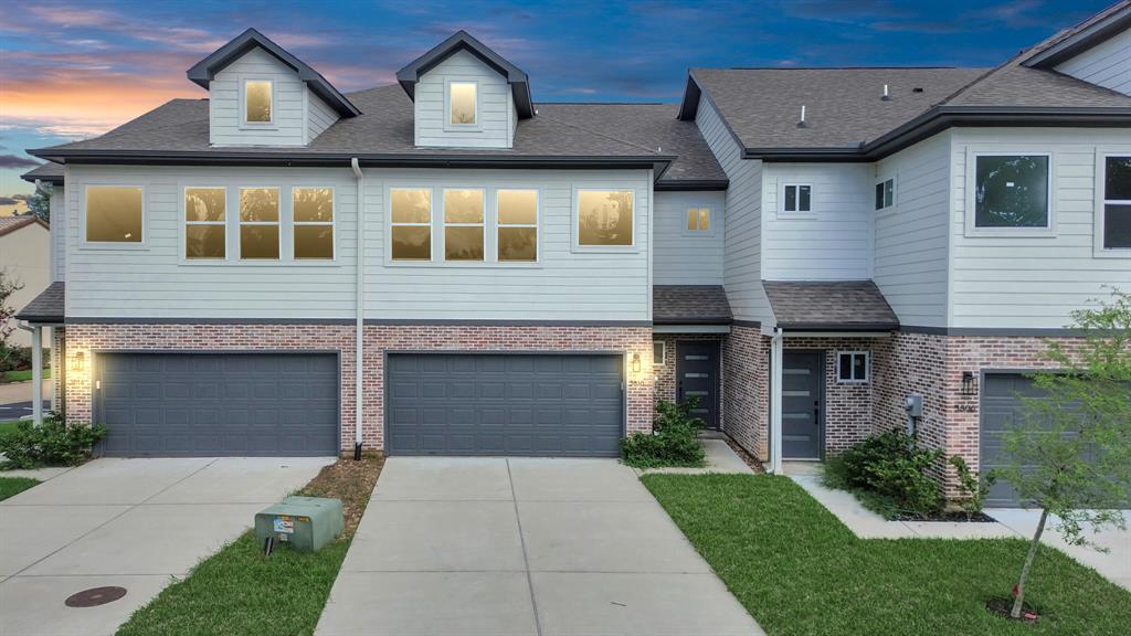 a front view of a house with a yard and a garage