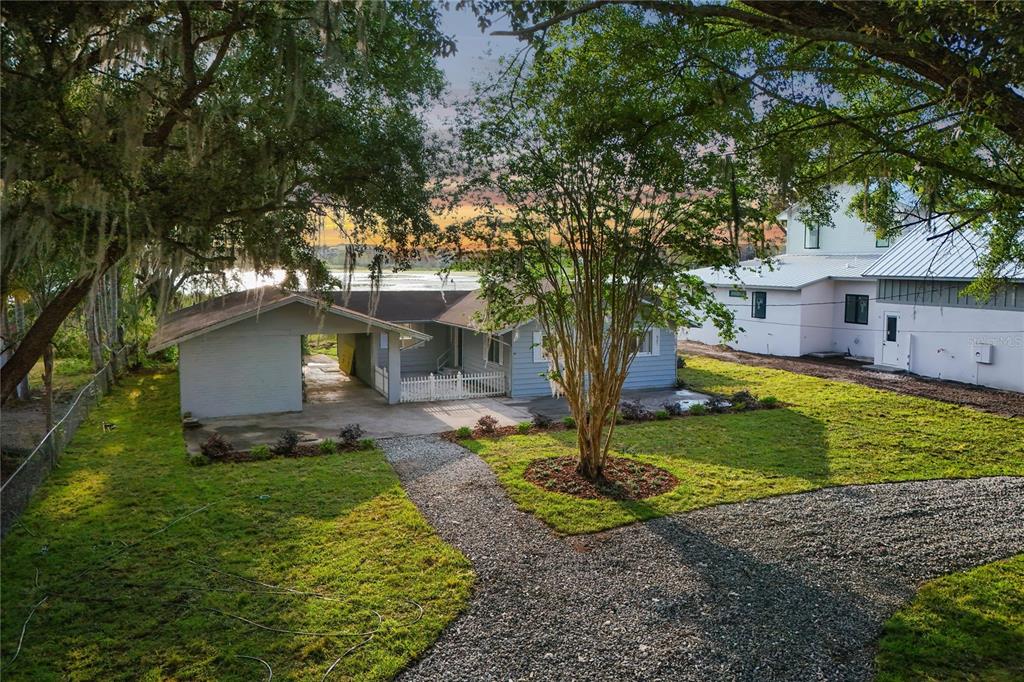 a view of a house with a yard and tree s