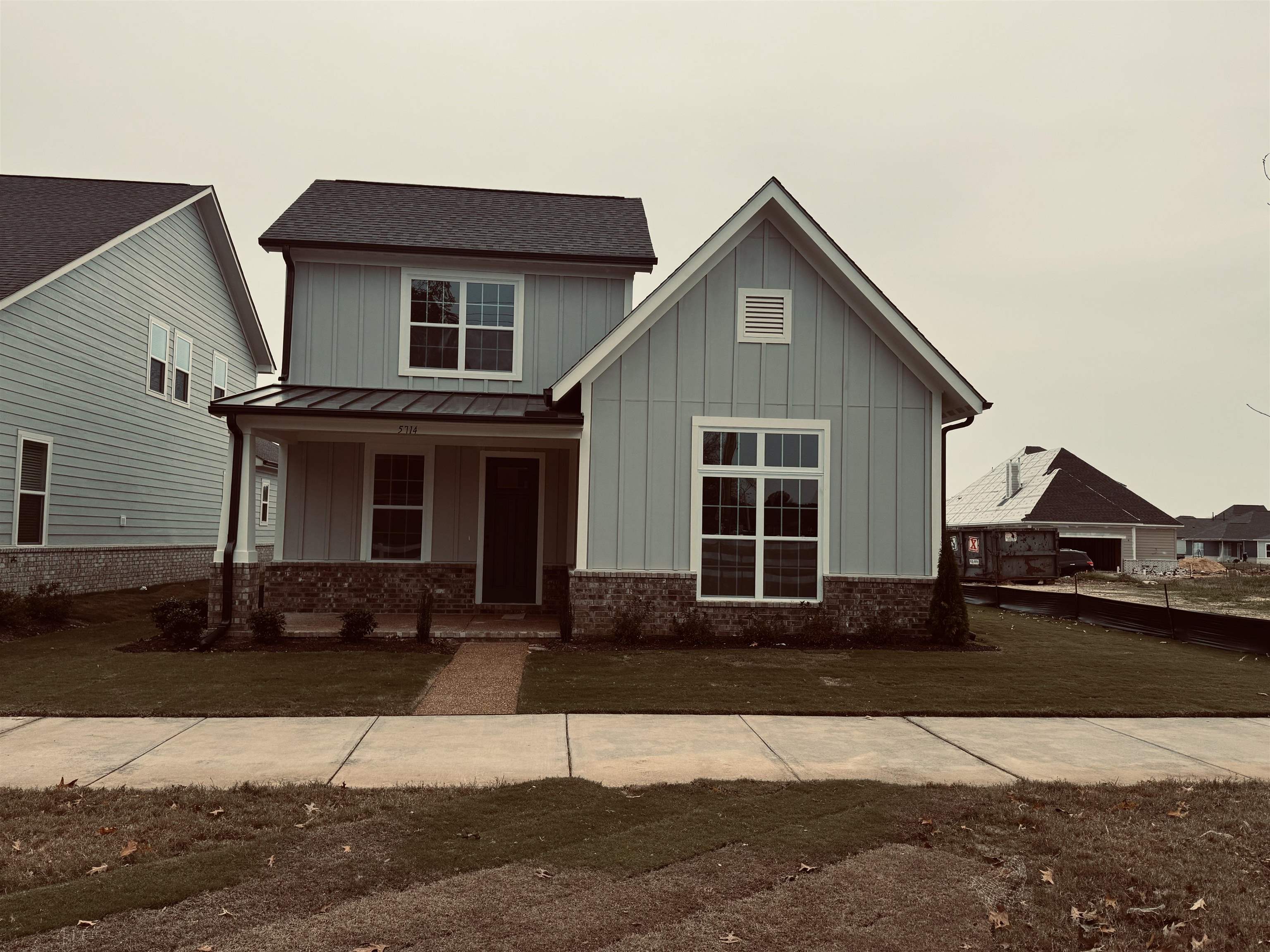 a front view of a house with yard and parking space