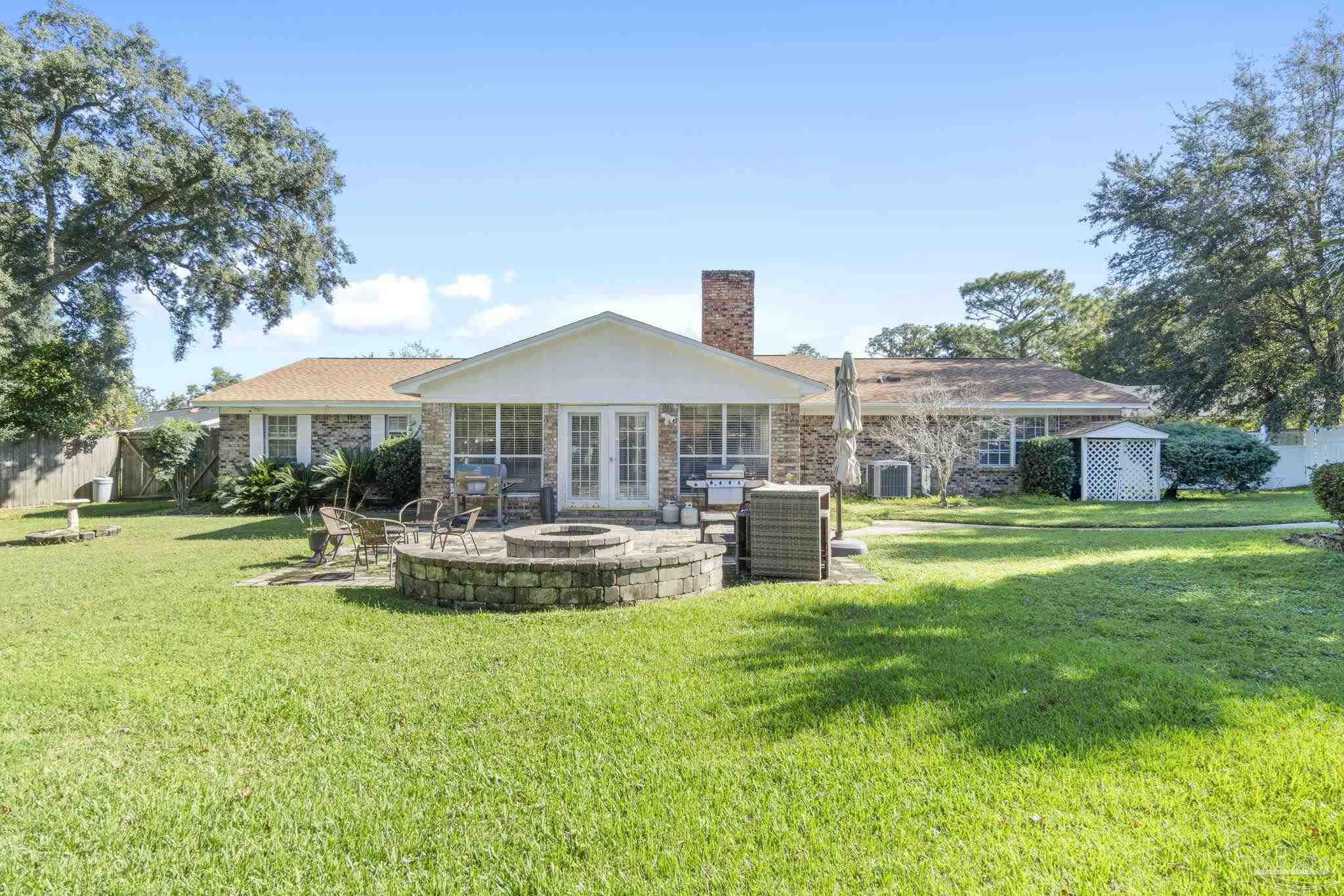 a front view of a house with swimming pool having outdoor seating