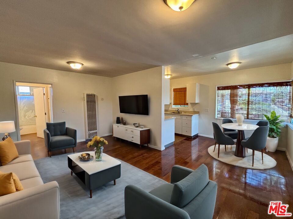 a living room with fireplace furniture and a flat screen tv