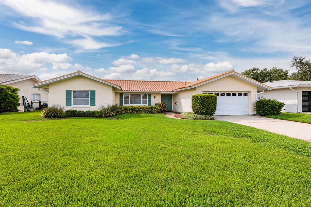 a front view of house with yard and green space