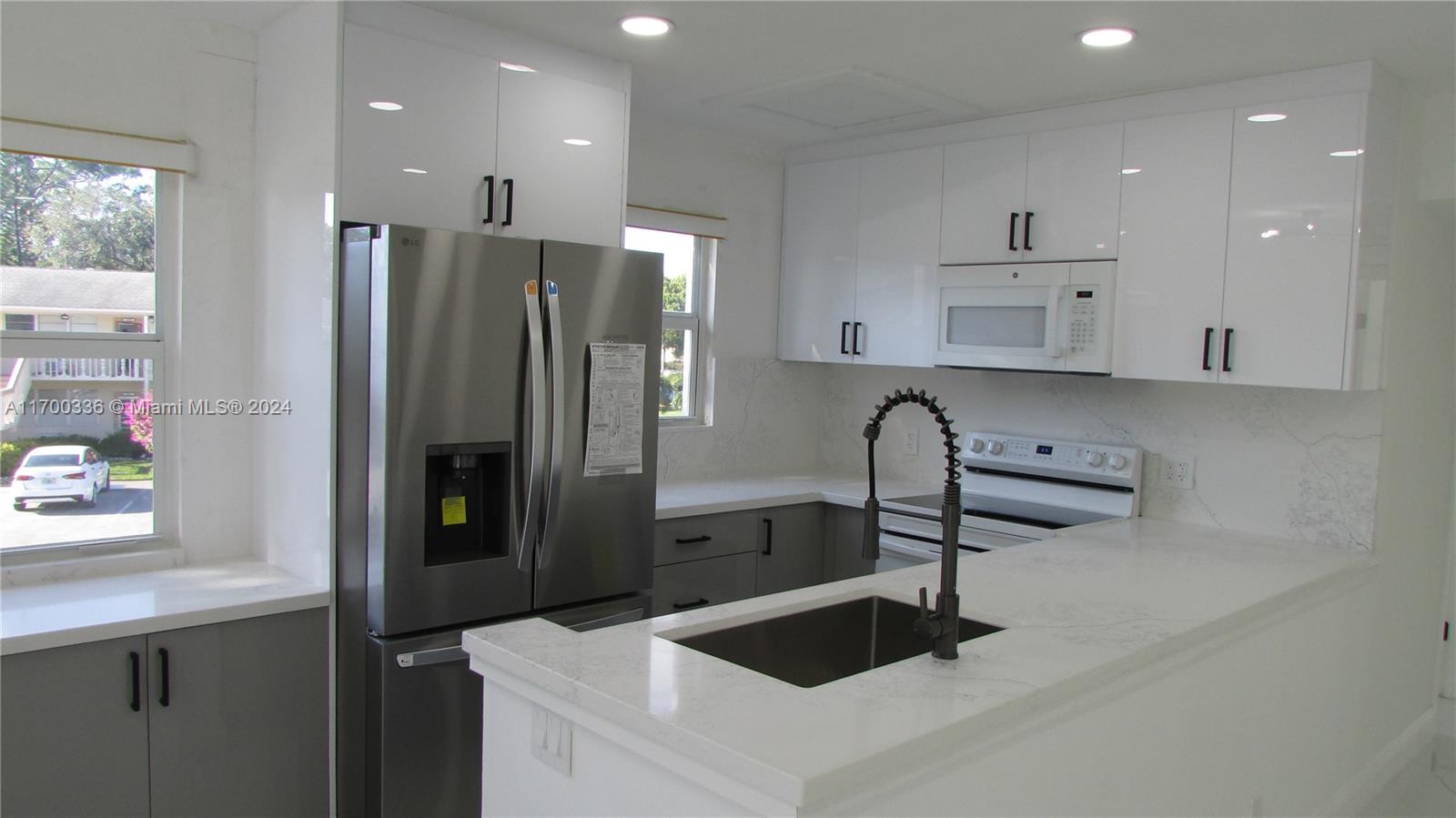 a kitchen with stainless steel appliances a refrigerator sink and stove