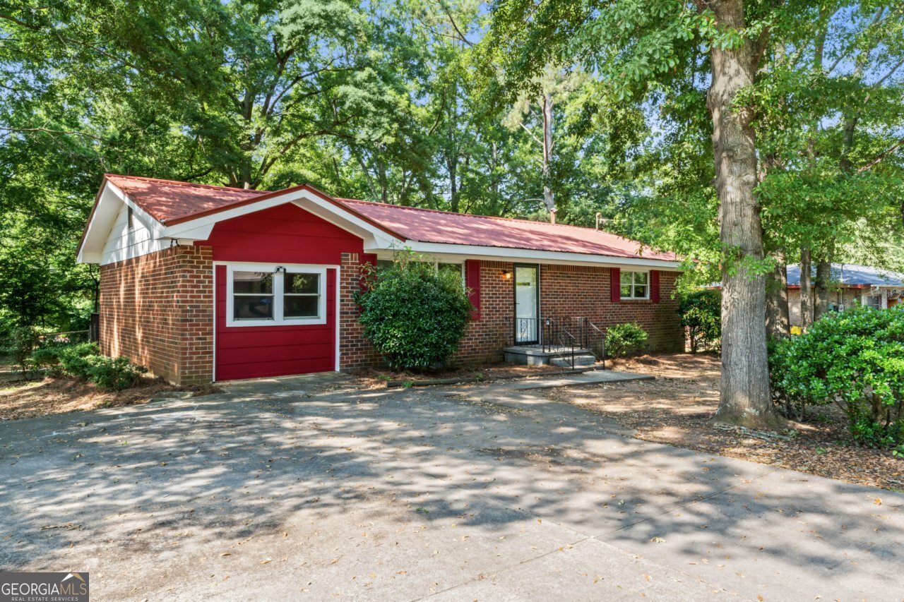 a front view of a house with yard and trees