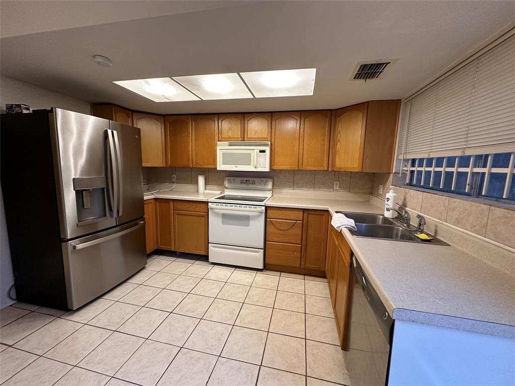 a kitchen with a sink a stove and refrigerator