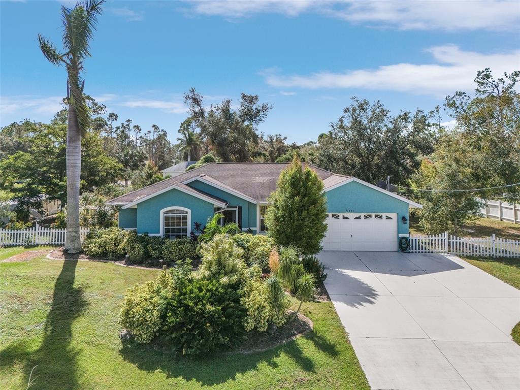 a front view of a house with a yard and trees