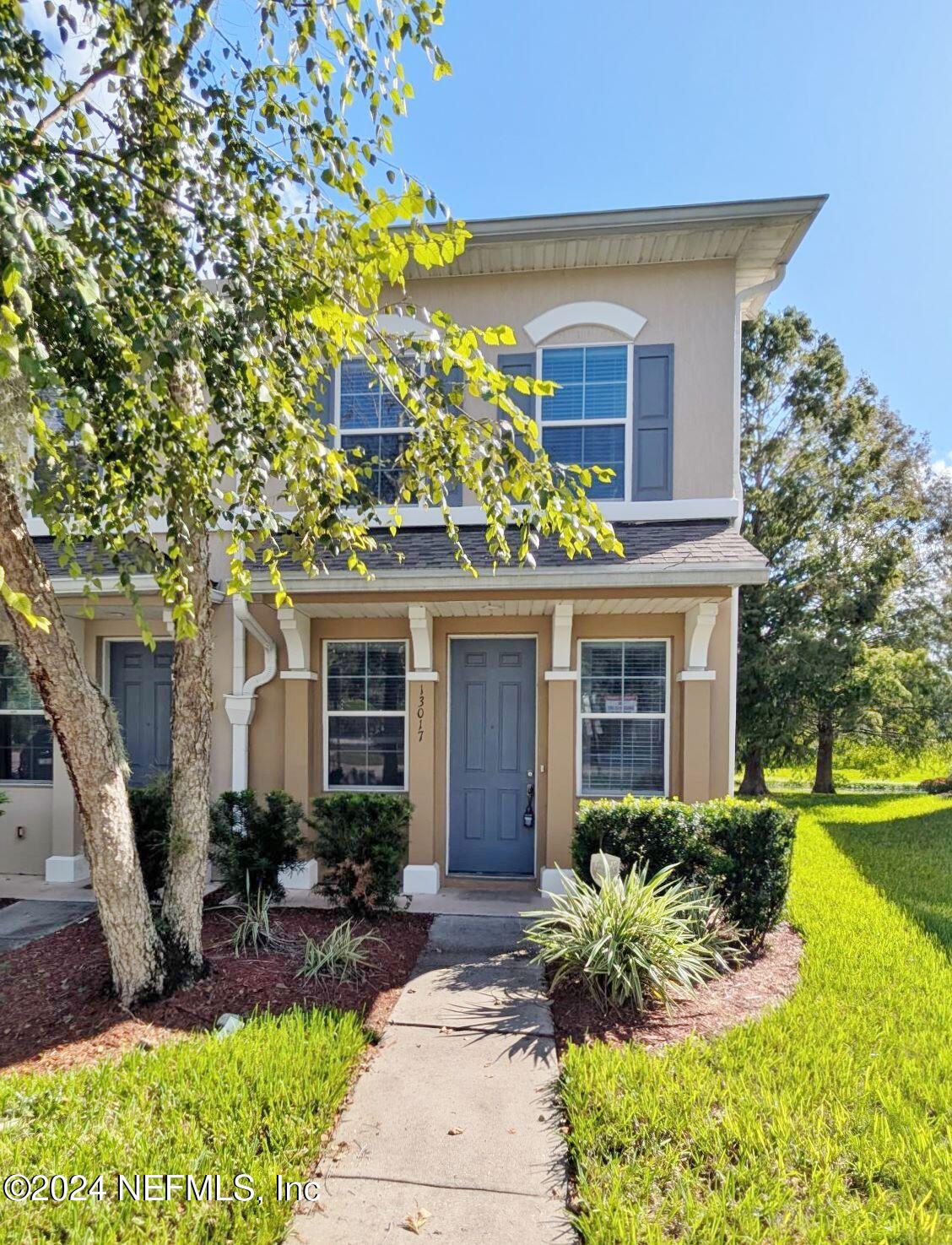 a front view of a house with garden