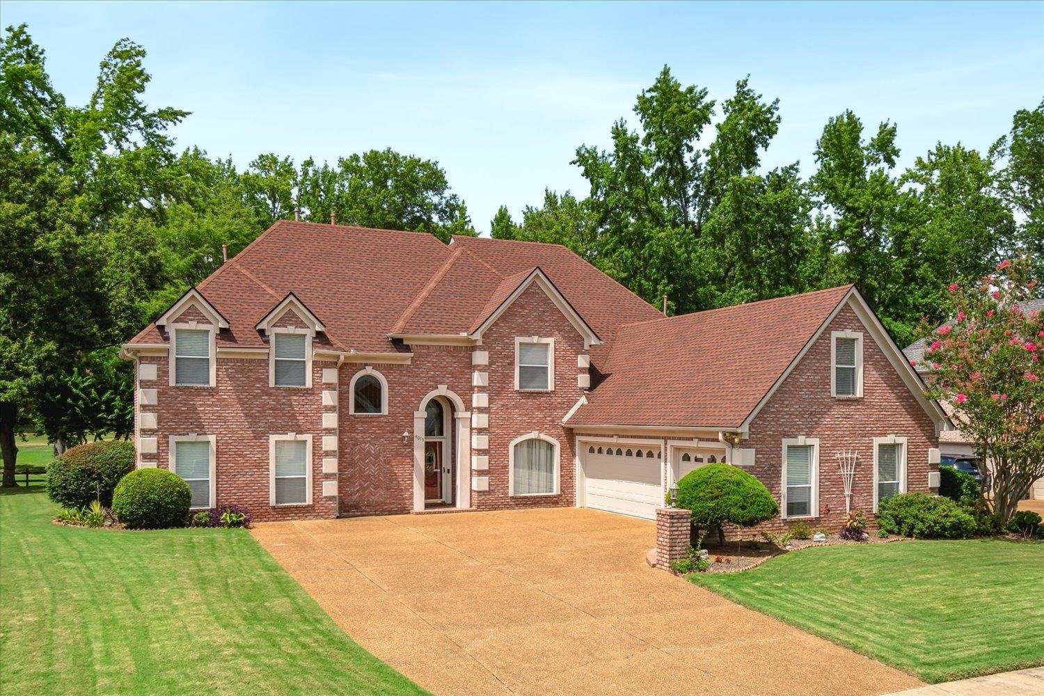 View of front of home with a garage and a front lawn