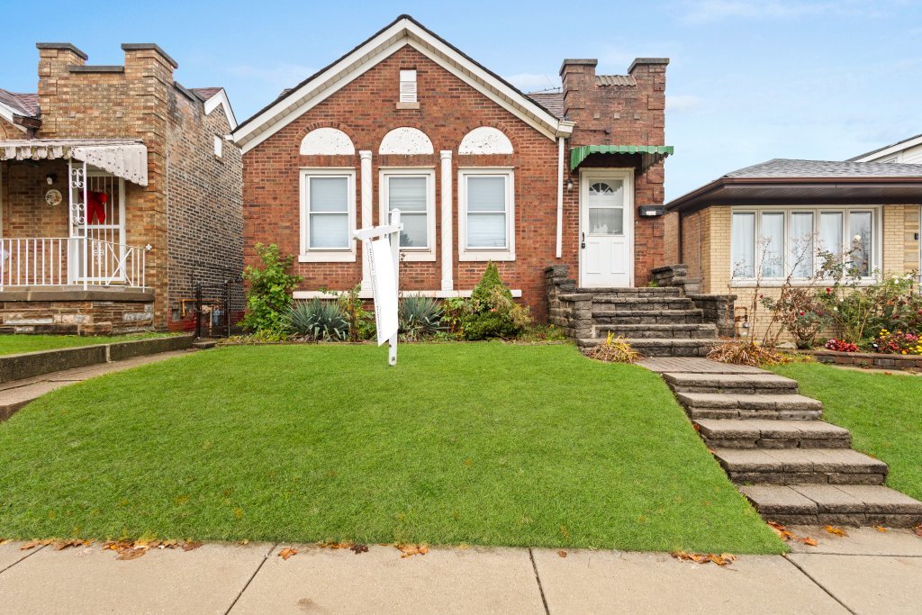 a front view of a house with a yard