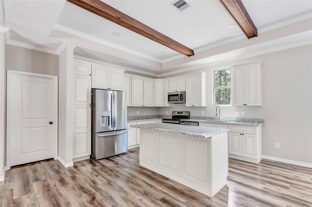 a kitchen with stainless steel appliances a refrigerator sink and stove