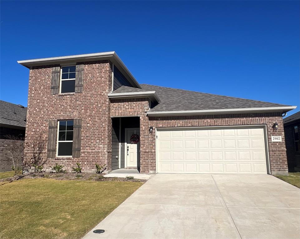 a front view of a house with garage