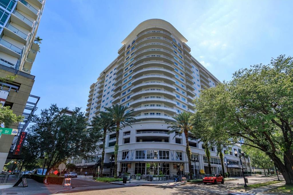 a view of a tall building next to a road