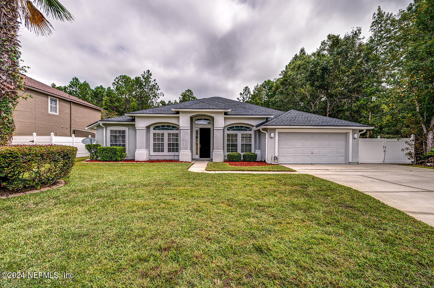 a front view of house with yard and green space