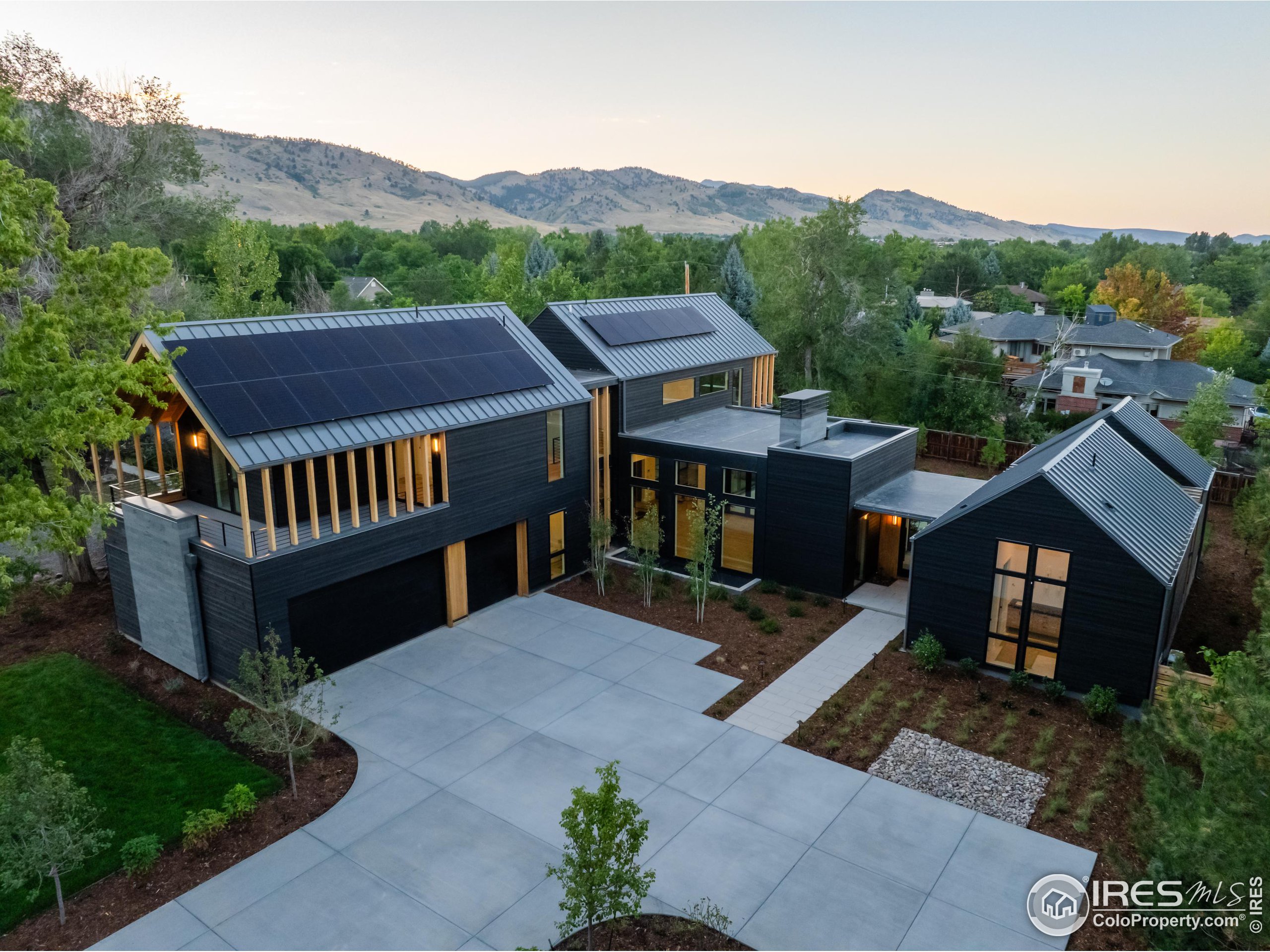 an aerial view of a house with swimming pool and mountain view