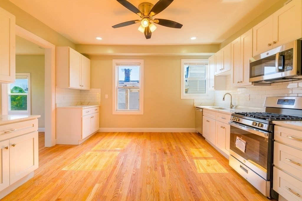 a kitchen with stainless steel appliances granite countertop a stove a sink and a refrigerator