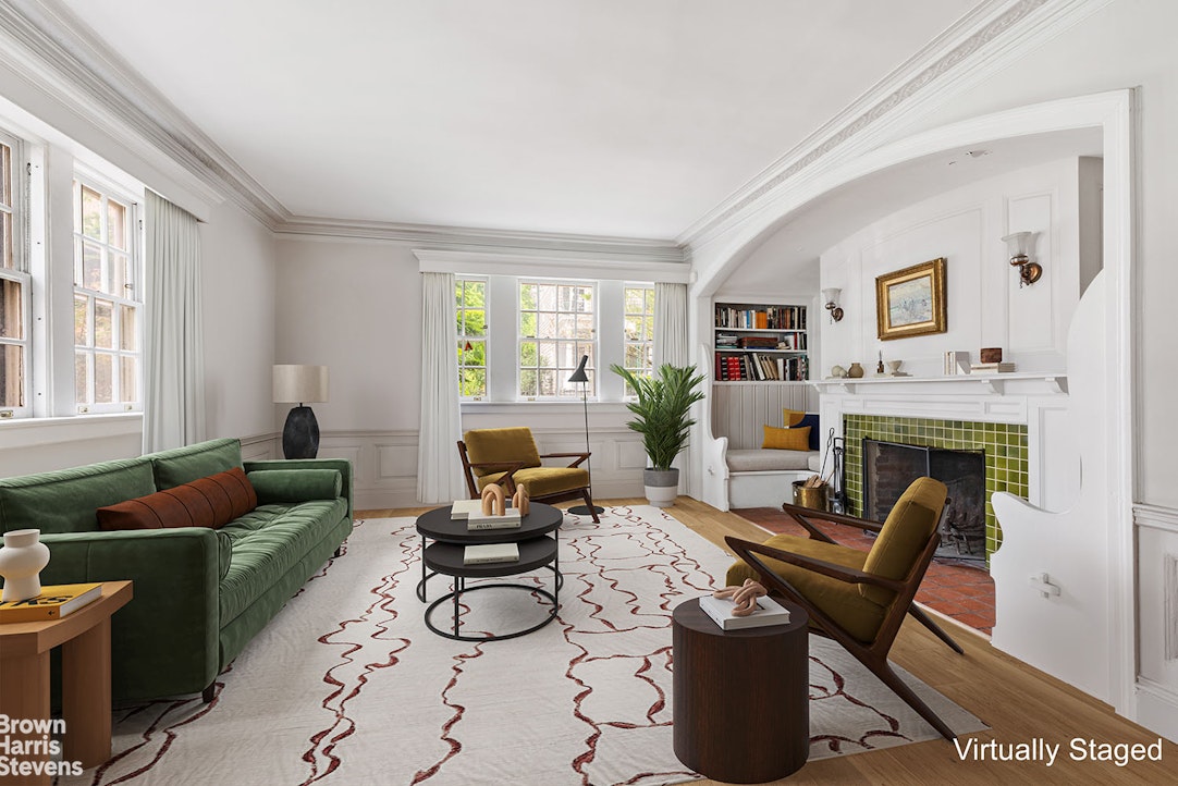 a living room with furniture a fireplace and a window