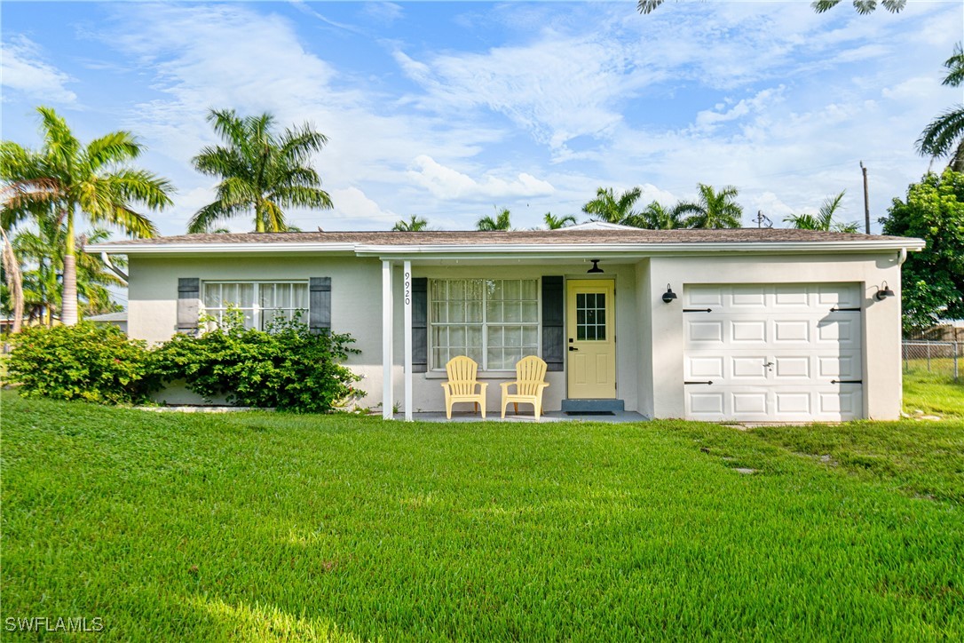 a view of a house with a yard and porch