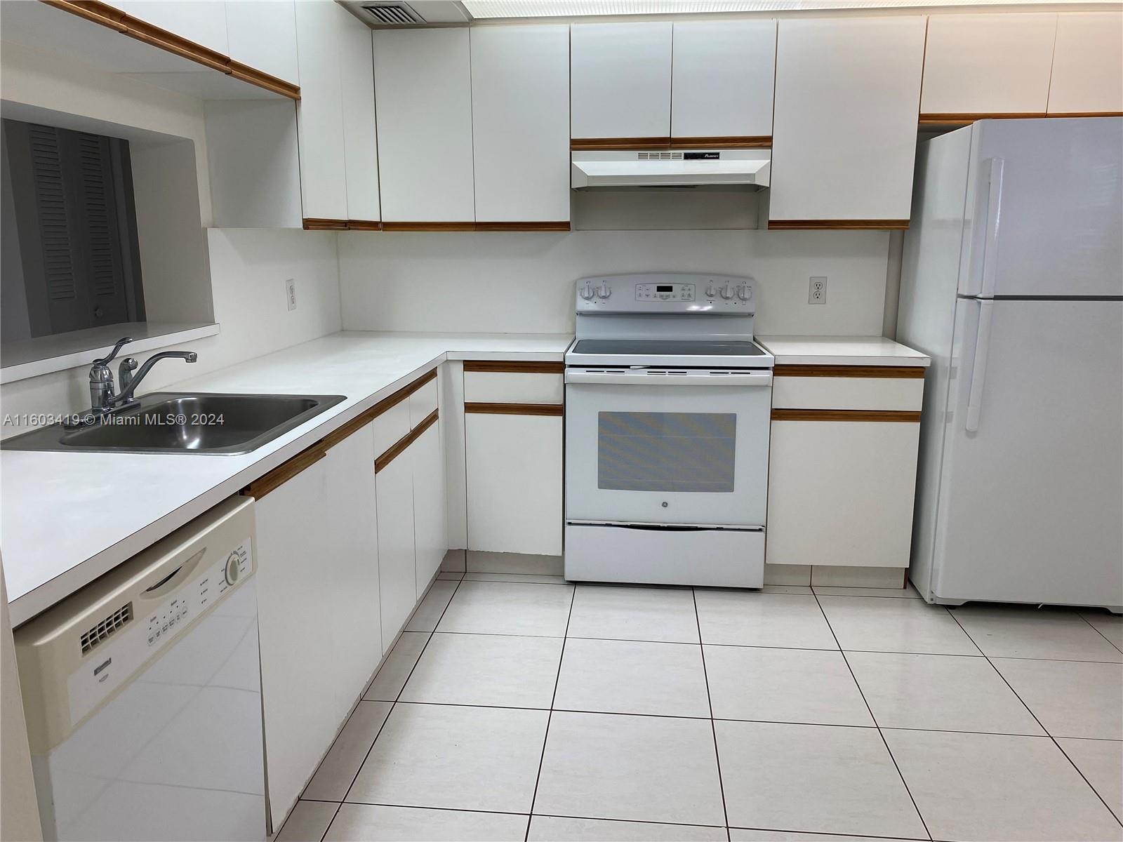 a kitchen with a sink a stove and cabinets