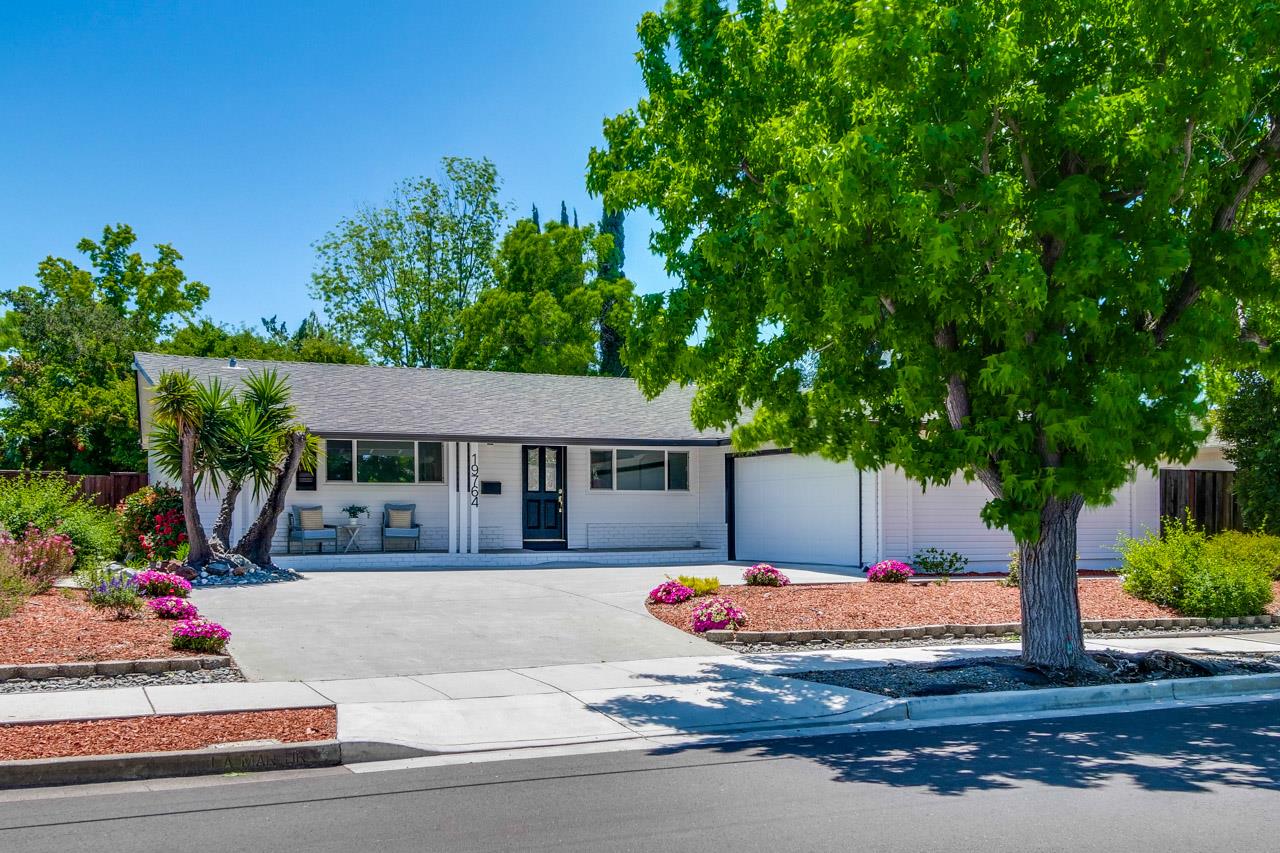 a front view of a house with a yard and a garage