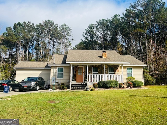 a front view of a house with a garden and trees