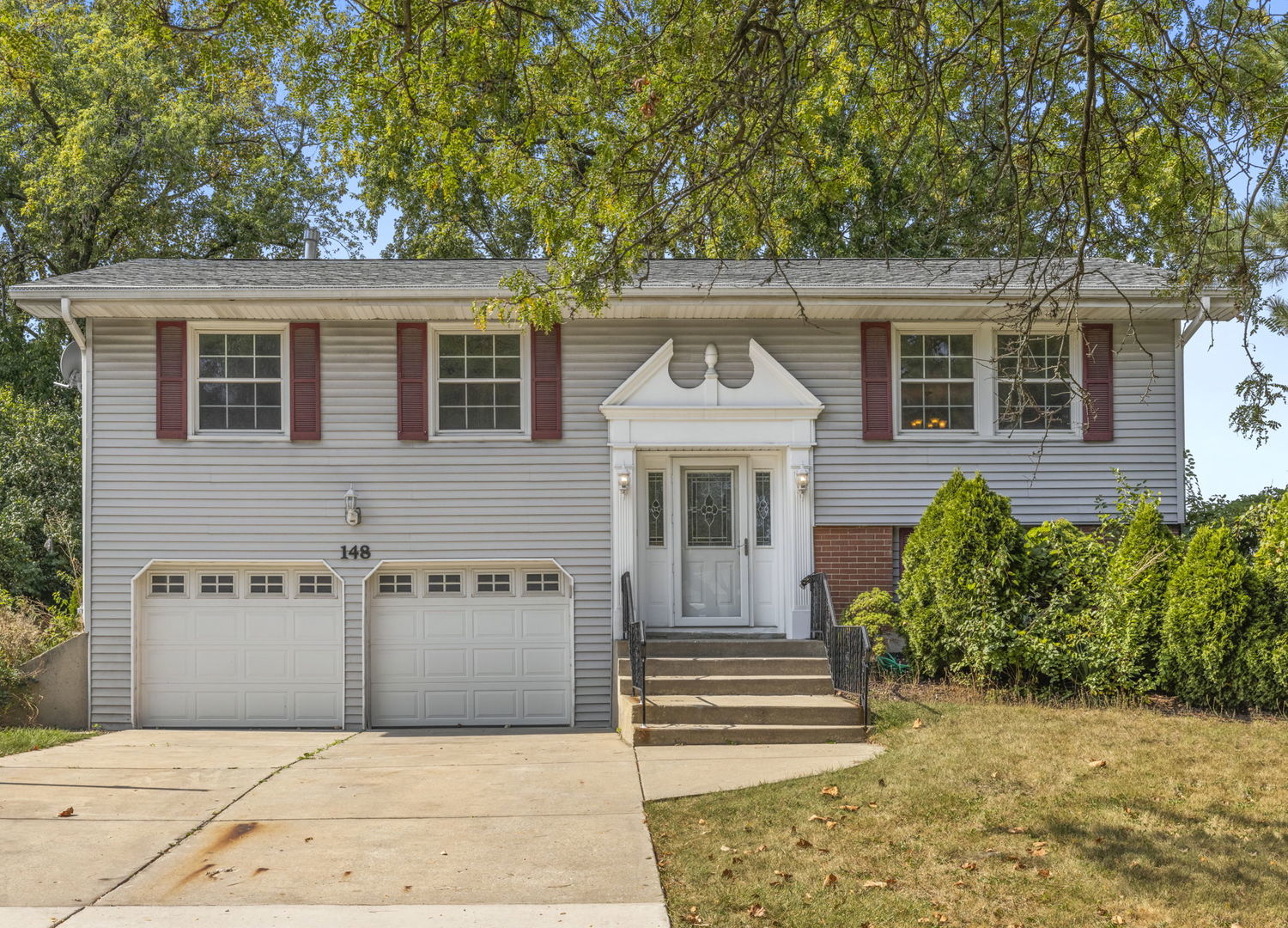 a front view of a house with a garden