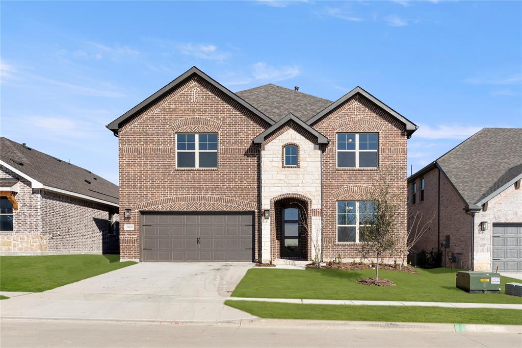 a front view of a house with a yard and garage