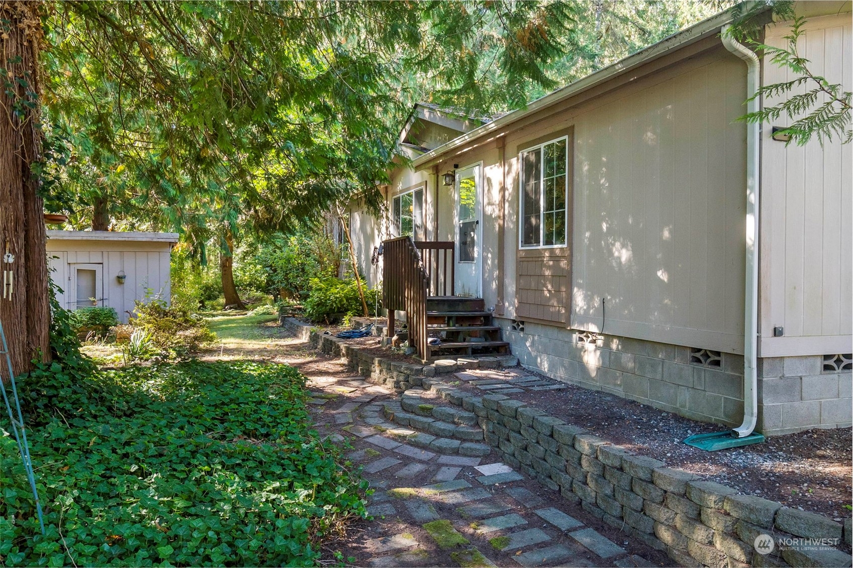 a view of a house with backyard and sitting area