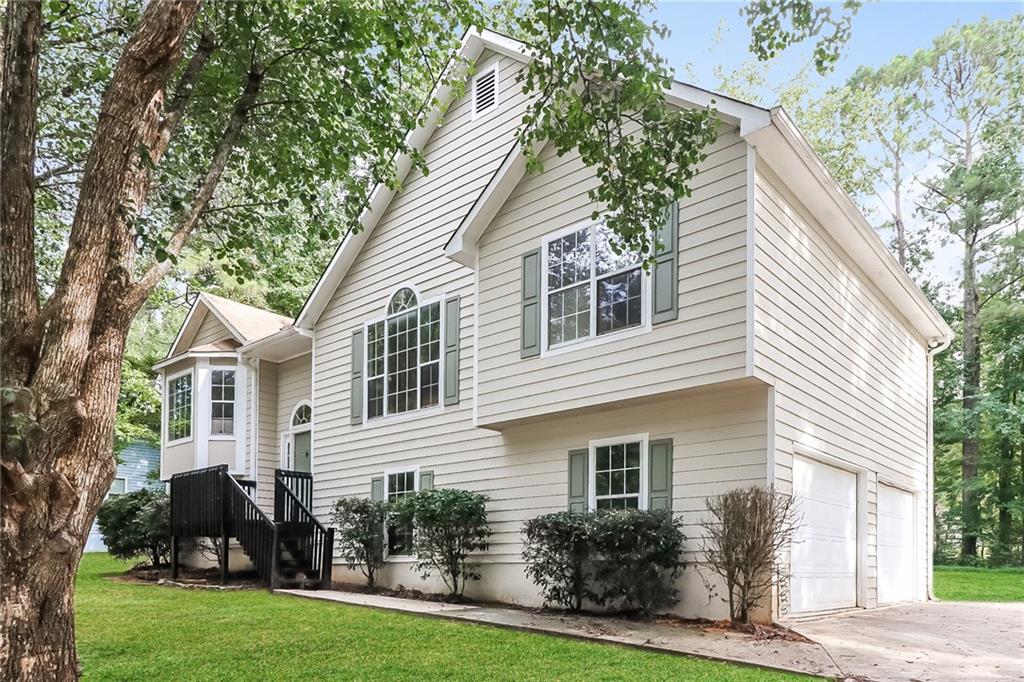 a front view of house with yard and green space